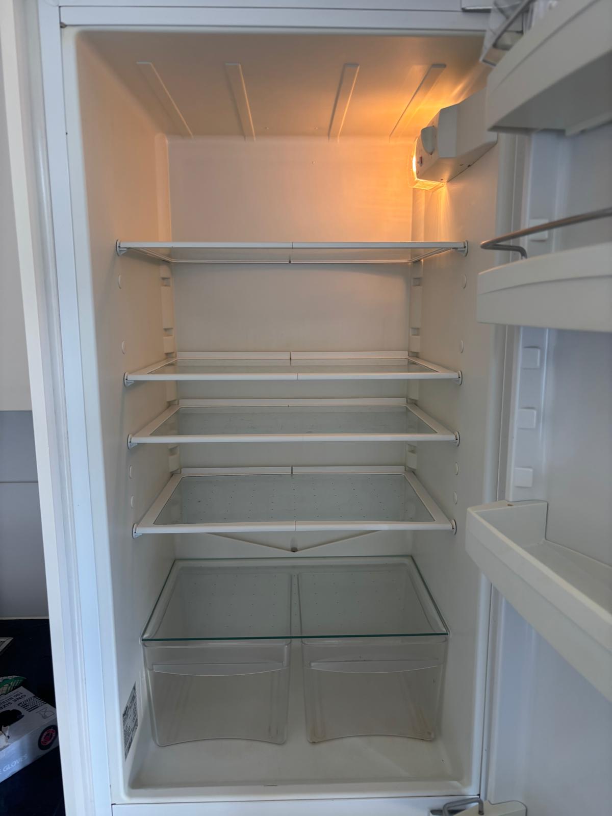 Clean refrigerator after move-out cleaning